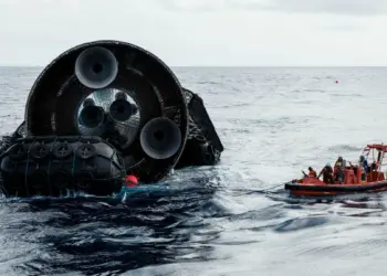 La parte posterior de Starship del Vuelo 13 flotando en el océano Índico junto a una embarcación de recuperación