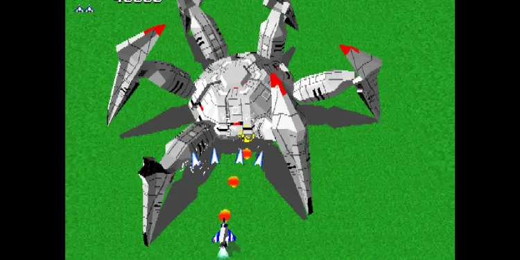 Combate contra un gran enemigo mecánico en Xevious 3D/G