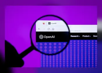 Una lupa amplía la página web de OpenAI en una pantalla